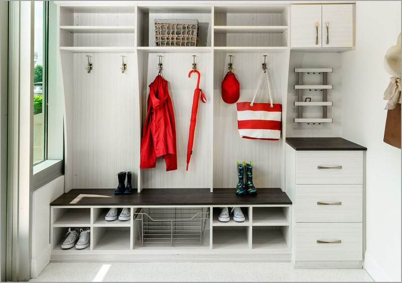 Clean entryway mudroom with shelves, hooks and drawers