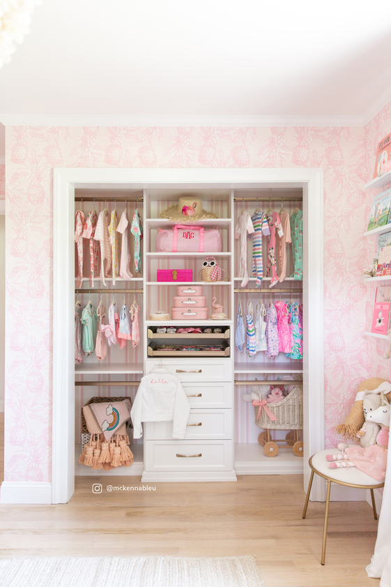 Organized baby and toddler closet with open shelves and drawers