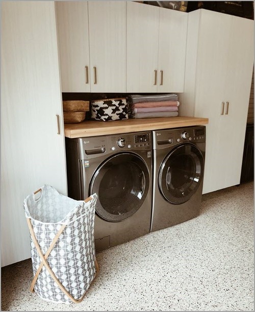 Custom designed laundry space with storage and organization solutions