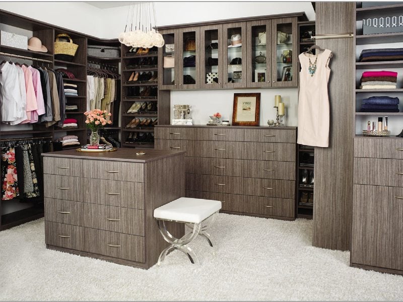 Custom closet storage with hanging rods, shelves, enclosed cabinets and drawers