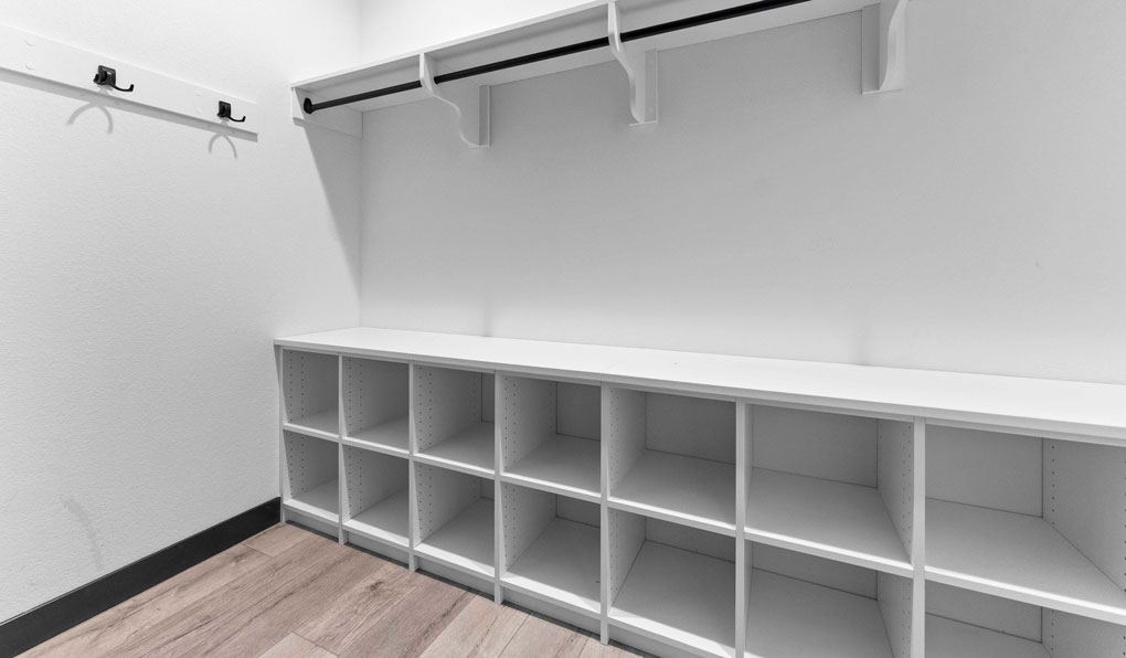 Customized mudroom storage with hooks and shelves